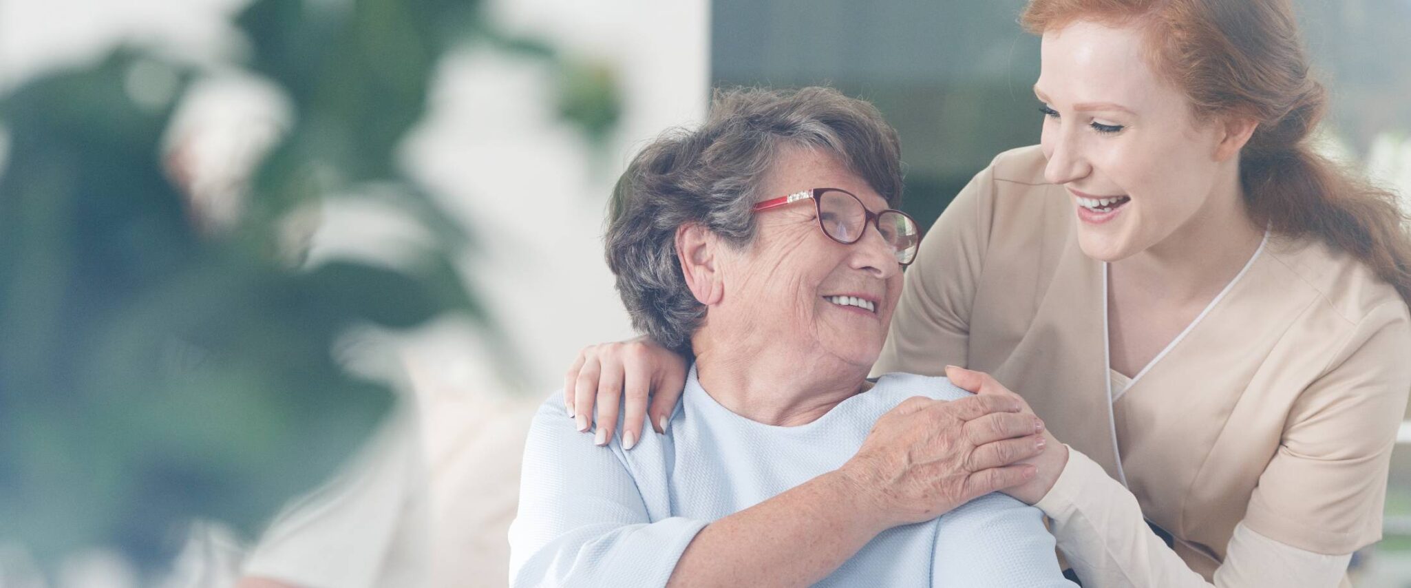 happy senior talking with nurse