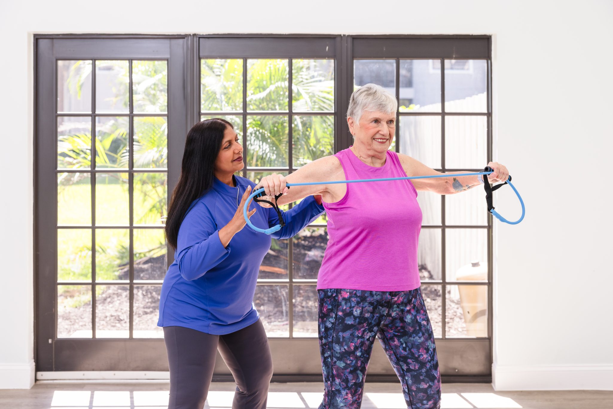 Senior woman working out with trainer