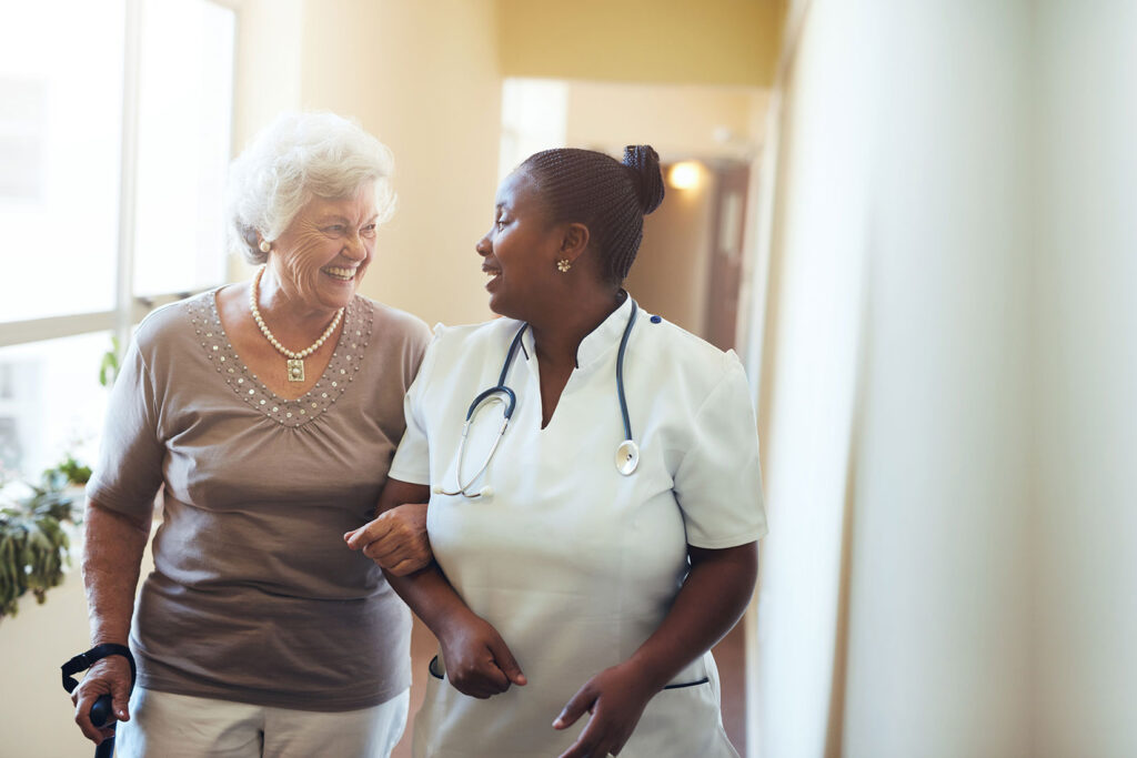 resident walking with a healthcare worker