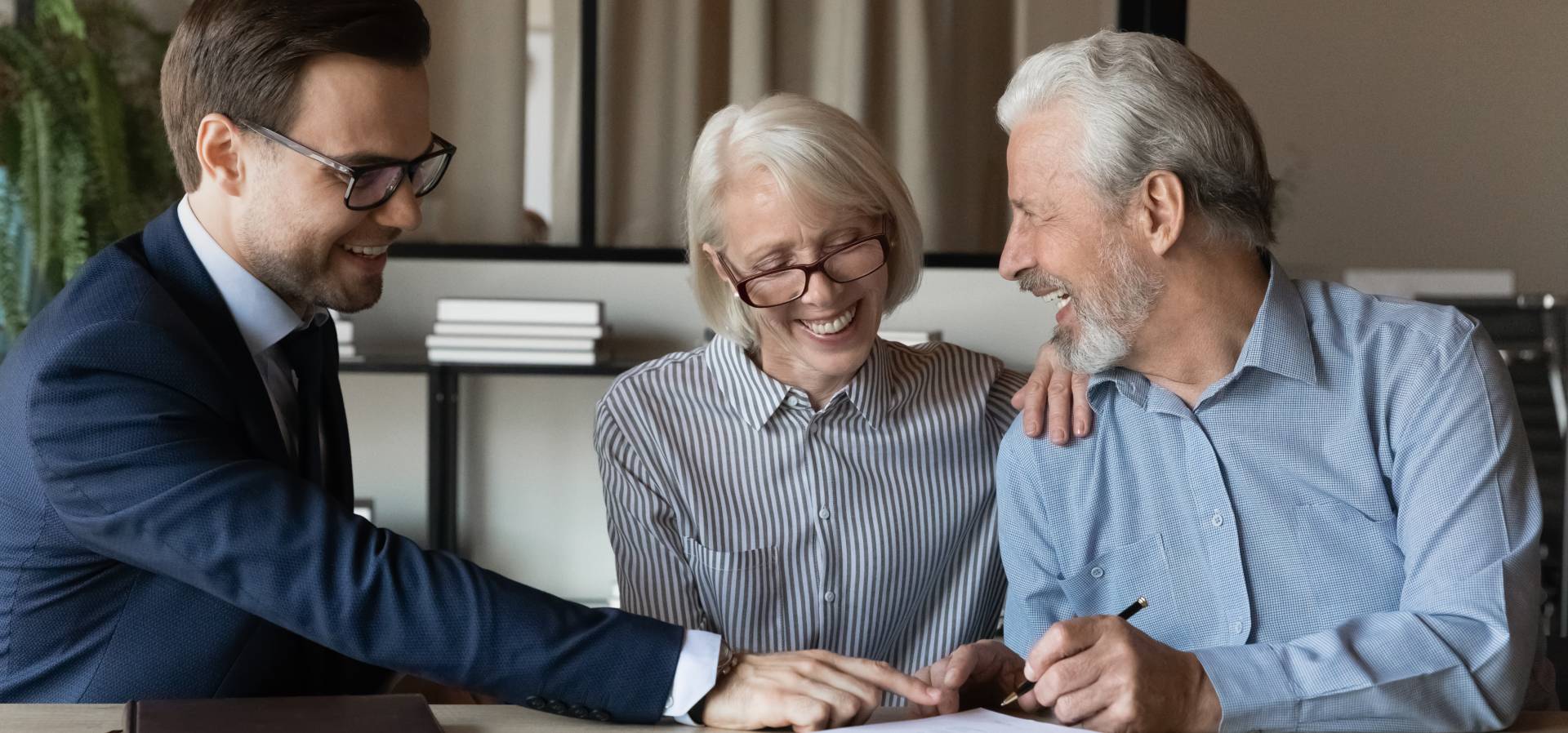 seniors looking over the cost of assisted living with a financial advisor