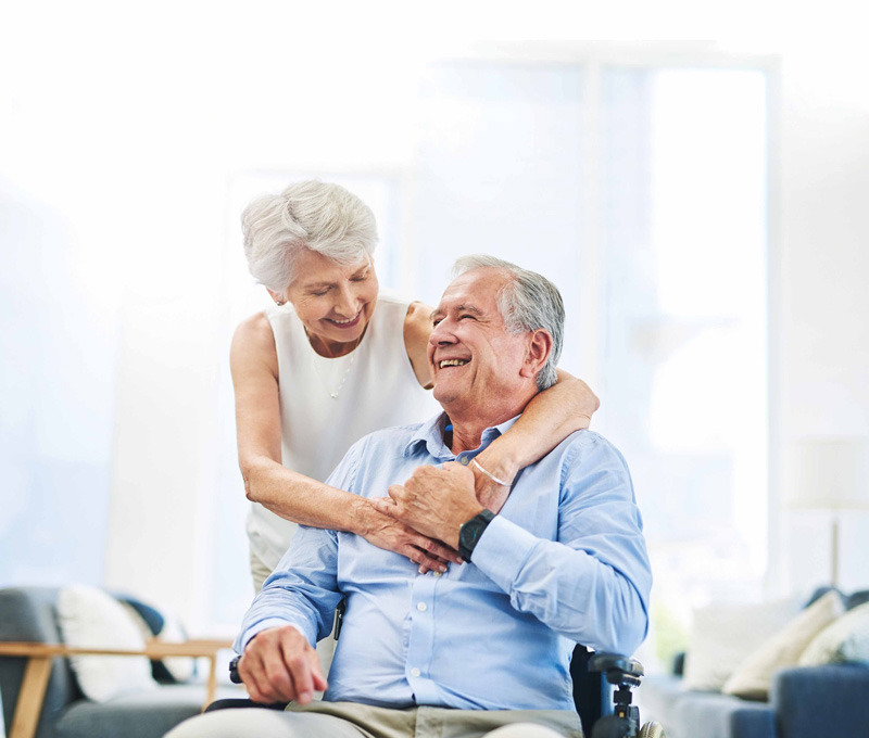 happy senior couple smiling and hugging