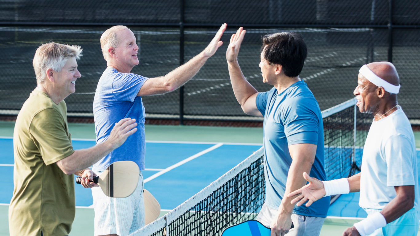Blog Images (87) Four senior men showing sportmanship after a game of pickleball