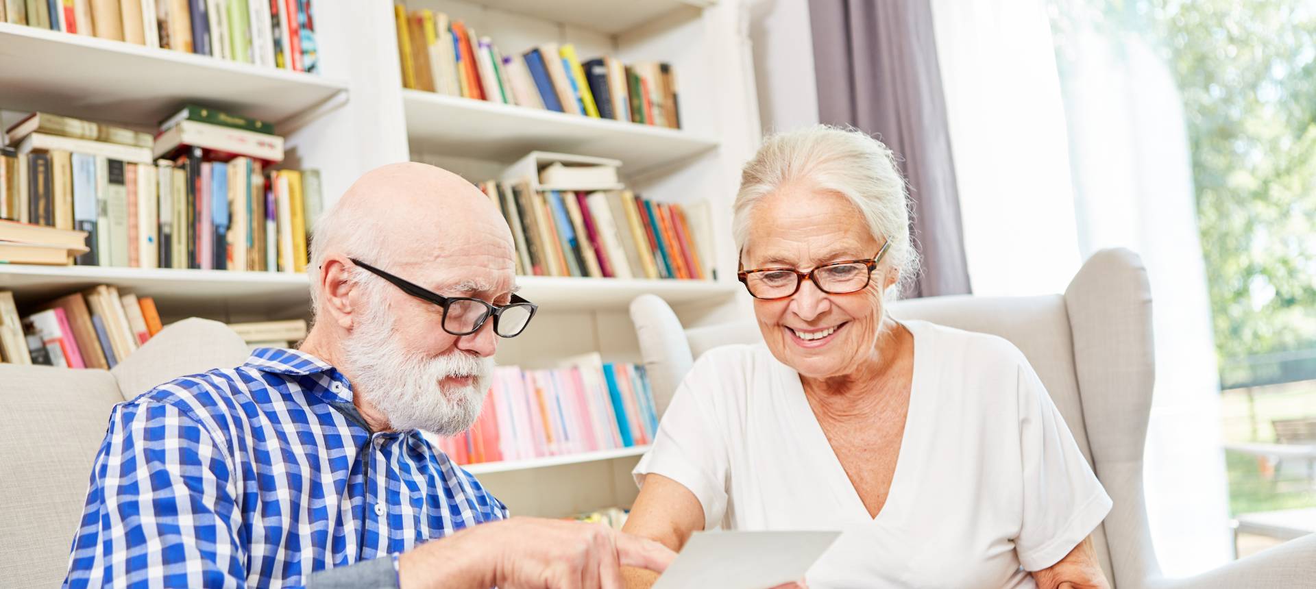 seniors in dementia care looking at old pictures together